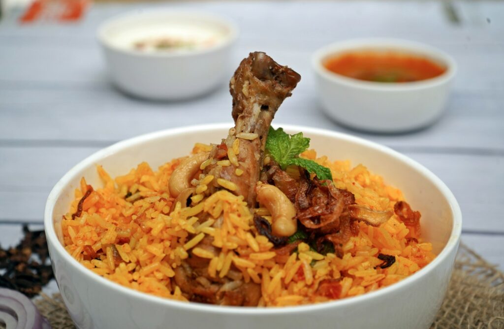 Authentic chicken biryani in Spain served in a white bowl with basmati rice