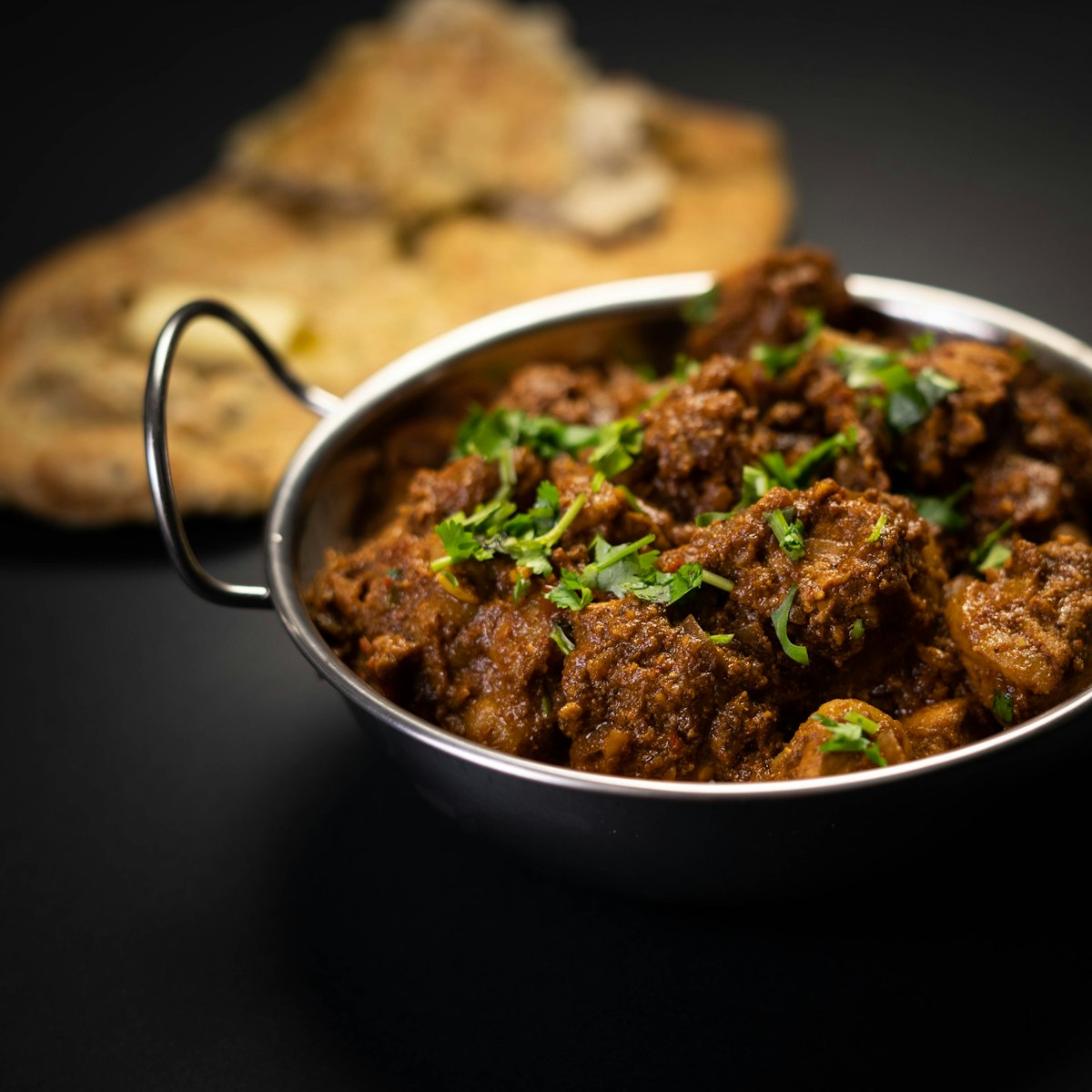 Beef Nihari in Spain - tender beef cooked in thick spiced gravy, served in a steel bowl