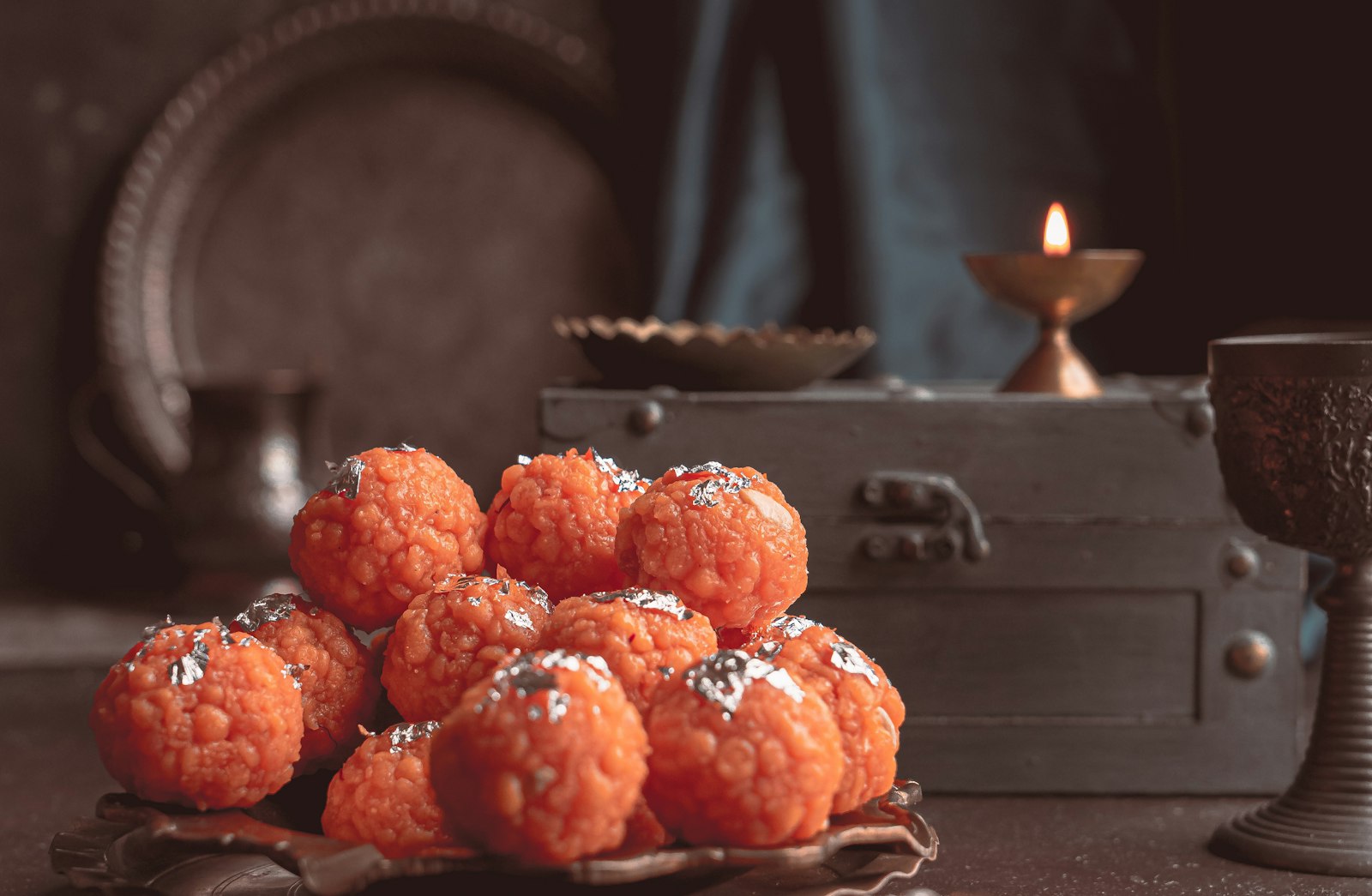 Diwali Sweets in Spain - festive sweets served beside a glowing candle