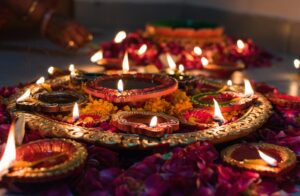 Diwali Sweets in Spain - lit clay diyas and flower petals for the festival of lights
