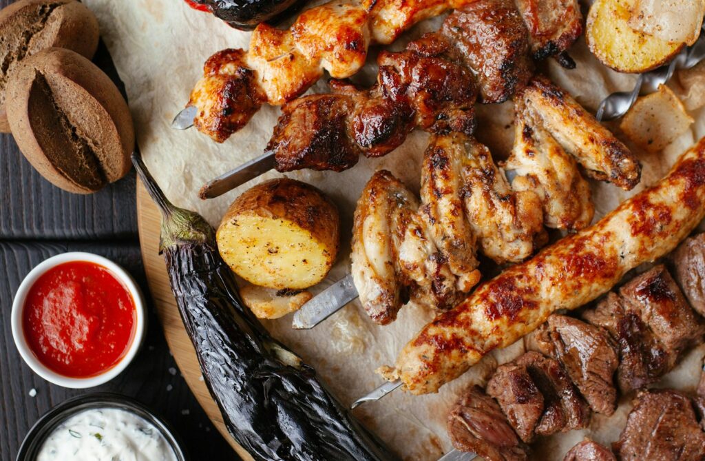 Halal Groceries in Spain - grilled halal meat skewers and vegetables on a family table