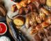 Halal Groceries in Spain - grilled halal meat skewers and vegetables on a family table